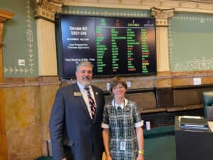 Holtorf and Mccormick in front of a tally board for sb21-248